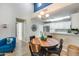 Charming dining area with wood table and modern light fixture at 14300 W Bell Rd # 480, Surprise, AZ 85374