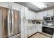 Bright kitchen featuring stainless steel appliances and white cabinetry at 14300 W Bell Rd # 480, Surprise, AZ 85374