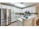 Modern kitchen with stainless steel appliances and white cabinets at 14300 W Bell Rd # 480, Surprise, AZ 85374