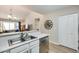 Kitchen with stainless steel sink and updated white cabinets at 14300 W Bell Rd # 480, Surprise, AZ 85374