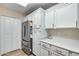 Kitchen boasts stainless steel refrigerator and white cabinets at 14300 W Bell Rd # 480, Surprise, AZ 85374