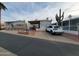 Two tan mobile homes side by side with carports and patios. A white SUV is parked in the driveway at 1494 W Pawnee Ave, Apache Junction, AZ 85119