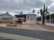 Mobile home with covered patio and desert landscaping at 1494 W Pawnee Ave, Apache Junction, AZ 85119