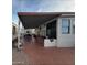 Extended covered patio with seating area and access to the mobile home at 1494 W Pawnee Ave, Apache Junction, AZ 85119