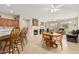 Bright dining area with a wooden table and chairs, adjacent to the kitchen at 15452 W Skyview Way, Surprise, AZ 85374