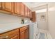 Bright laundry room with washer, dryer and storage cabinets at 15452 W Skyview Way, Surprise, AZ 85374