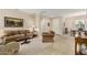 Living room with tiled floors, comfortable seating, and a view into the dining area at 15452 W Skyview Way, Surprise, AZ 85374