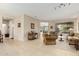 Spacious living room with tiled floors and neutral color palette at 15452 W Skyview Way, Surprise, AZ 85374