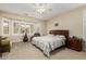 Main bedroom with a large bed, ample closet space, and window seating at 15452 W Skyview Way, Surprise, AZ 85374