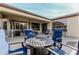 Covered patio with seating area and fire pit, ideal for outdoor entertaining at 15452 W Skyview Way, Surprise, AZ 85374