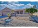 One-story house with desert landscaping, attached garage, and neutral color scheme at 15665 W Azalea Ln, Surprise, AZ 85374