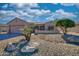 Single-story home with desert landscaping and a two-car garage at 15665 W Azalea Ln, Surprise, AZ 85374