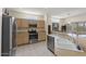 Modern kitchen with stainless steel appliances and light wood cabinets at 15665 W Azalea Ln, Surprise, AZ 85374