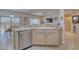 Kitchen with stainless steel dishwasher and light wood cabinets at 15665 W Azalea Ln, Surprise, AZ 85374