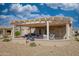 Backyard patio with pergola and seating area at 15665 W Azalea Ln, Surprise, AZ 85374