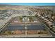 Aerial view of a residential area with a school and large parking lot at 17680 W Lilac St, Goodyear, AZ 85338