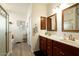 Double vanity bathroom with wood cabinets and a large mirror at 17680 W Lilac St, Goodyear, AZ 85338