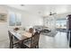 Bright dining area with wood table and chairs, view to living room and backyard at 17680 W Lilac St, Goodyear, AZ 85338