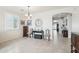 Elegant dining room with a chandelier and access to the kitchen at 17680 W Lilac St, Goodyear, AZ 85338