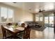 Bright dining area with a table and chairs, adjacent to living room at 17680 W Lilac St, Goodyear, AZ 85338