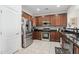 Modern kitchen with stainless steel appliances and dark wood cabinets at 17680 W Lilac St, Goodyear, AZ 85338