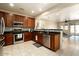 Spacious kitchen featuring dark wood cabinets and stainless steel appliances at 17680 W Lilac St, Goodyear, AZ 85338