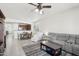 Open concept living room with grey sectional sofa and view of kitchen at 17680 W Lilac St, Goodyear, AZ 85338