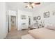 Main bedroom with a queen bed, white and pink decor, and a walk-in closet at 17680 W Lilac St, Goodyear, AZ 85338