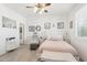 Main bedroom with a queen bed, white and pink decor, and a walk-in closet at 17680 W Lilac St, Goodyear, AZ 85338