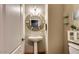 Small powder room with pedestal sink and decorative mirror at 1806 E Ellis St, Phoenix, AZ 85042