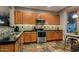 Modern kitchen with stainless steel appliances and wood cabinets at 1806 E Ellis St, Phoenix, AZ 85042