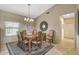 Elegant dining room with a chandelier and seating for six at 18137 N Estrella Vista Dr, Surprise, AZ 85374