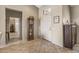 Bright entryway with tile flooring, a grandfather clock, and built-in shelving at 18137 N Estrella Vista Dr, Surprise, AZ 85374