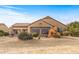 Rear view of house with large windows and desert landscaping at 18137 N Estrella Vista Dr, Surprise, AZ 85374