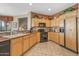 Modern kitchen with wood cabinetry and stainless steel appliances at 18137 N Estrella Vista Dr, Surprise, AZ 85374