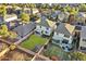 Aerial view of a backyard with a kidney bean grass area, patio, garden, and wooden fence at 18260 W Bridger St, Surprise, AZ 85388