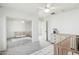 Bedroom with ceiling fan, window, gray carpet, wooden crib, and a dresser at 18260 W Bridger St, Surprise, AZ 85388