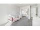 White Bedroom with gray carpet, window, crib, and mirrored closet at 18260 W Bridger St, Surprise, AZ 85388