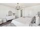 Inviting main bedroom with dark floors, chandelier and dresser at 18260 W Bridger St, Surprise, AZ 85388