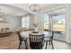 Charming dining area with a round table, modern chairs, and sliding glass doors to the patio at 18260 W Bridger St, Surprise, AZ 85388