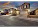 Charming two-story home featuring a two-car garage, stone accents, and well-lit exterior at 18260 W Bridger St, Surprise, AZ 85388