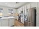 Contemporary kitchen showcasing stainless steel appliances, white cabinetry, and wood-style flooring at 18260 W Bridger St, Surprise, AZ 85388