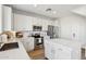 Modern kitchen featuring white cabinets, stainless steel appliances, and a center island for food preparation at 18260 W Bridger St, Surprise, AZ 85388