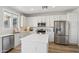 Modern kitchen showcasing stainless appliances, quartz countertops, and ample cabinet space at 18260 W Bridger St, Surprise, AZ 85388