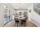 Open-concept kitchen with stainless steel appliances, white cabinetry, and a view of the dining area at 18260 W Bridger St, Surprise, AZ 85388