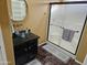 Bathroom with glass shower and dark vanity at 18803 N 16Th Pl, Phoenix, AZ 85024