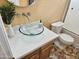 Bathroom features a glass vessel sink, updated vanity, and tiled flooring at 18803 N 16Th Pl, Phoenix, AZ 85024