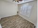 Bright bedroom with wood-look tile floor, window shutters, and ceiling fan at 18803 N 16Th Pl, Phoenix, AZ 85024