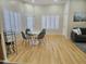 Bright dining area with hardwood floors and white table at 18803 N 16Th Pl, Phoenix, AZ 85024