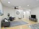 Living room with hardwood floors, gray couch, and large clock at 18803 N 16Th Pl, Phoenix, AZ 85024